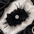 Black satin bow with feathers